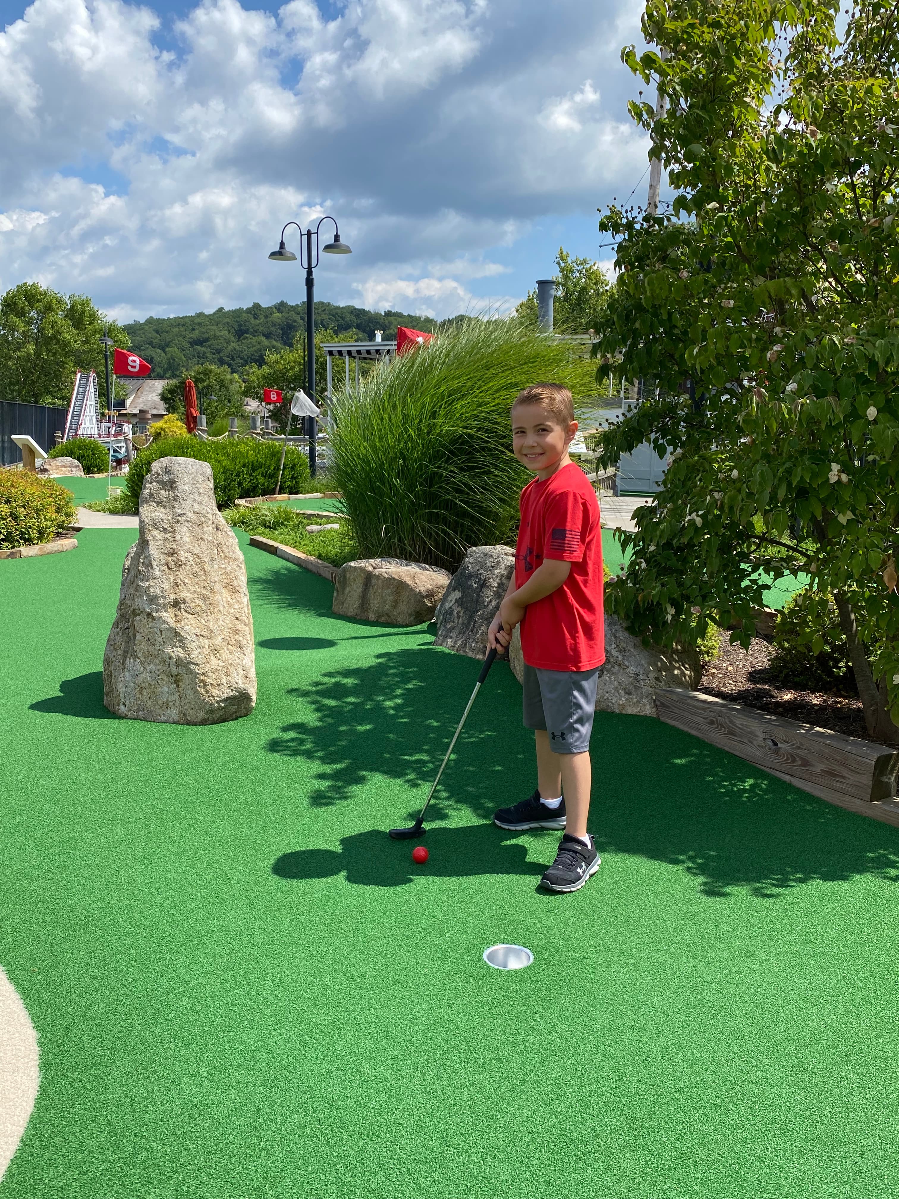 Boy Playing Mini Golf