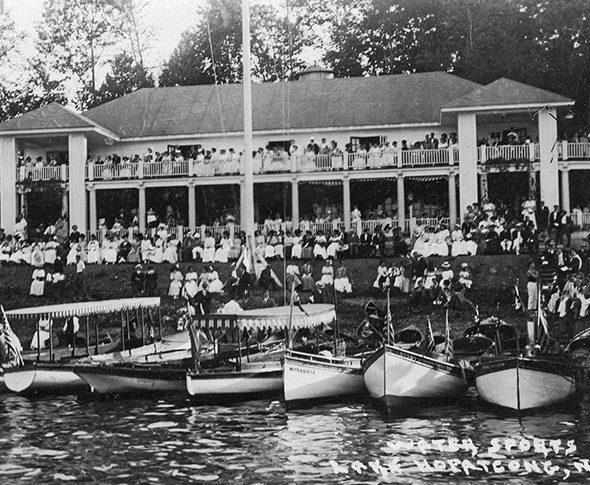 Boats and crowds of people in front of the Lake Hopatcong Yacht Club.