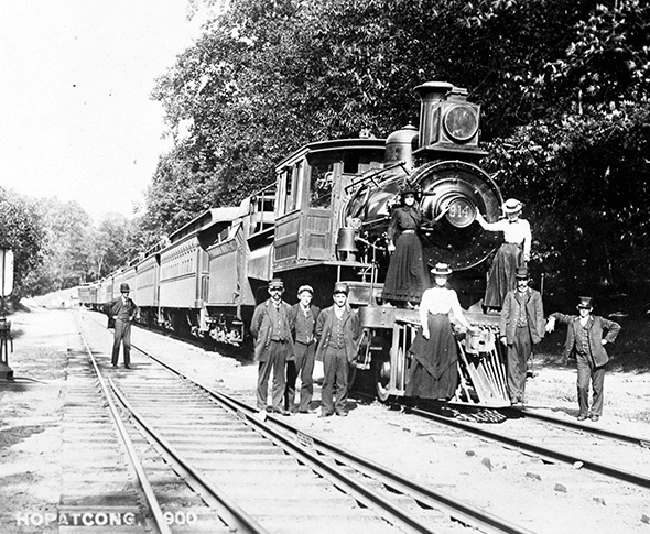 A group of people in front of a train.